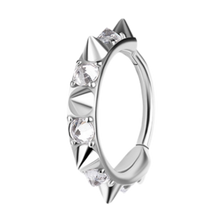 Load image into Gallery viewer, A silver-toned cobalt chrome nickel free hinged ring decorated with multiple sharp conical spikes and clear upside down gemstones, shown on a plain white background.