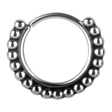 A continuous ring with a granulated tribal design, made from surgical steel.