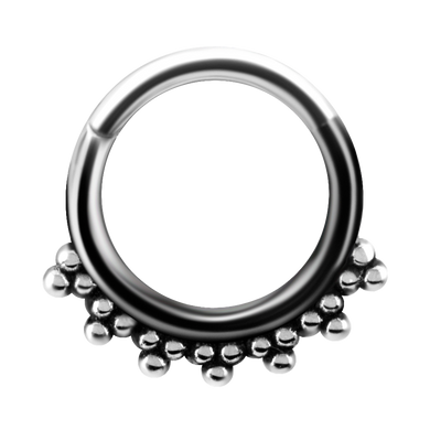 A steel tribal hinged ring with granulated details and a hinged center.