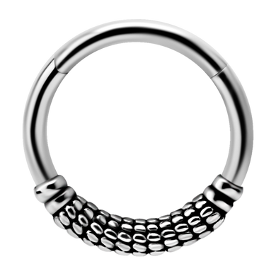 A single steel hinged ring with a patterned design, suitable for use as body piercing jewellery.