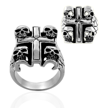 Load image into Gallery viewer, A high polished stainless steel ring with a cross design and four tiny skulls on each corner, shown from different angles.

